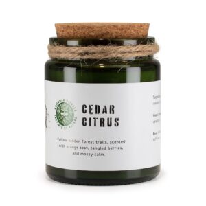Greenman Cedar Citrus soy candle in a green glass jar with cork lid