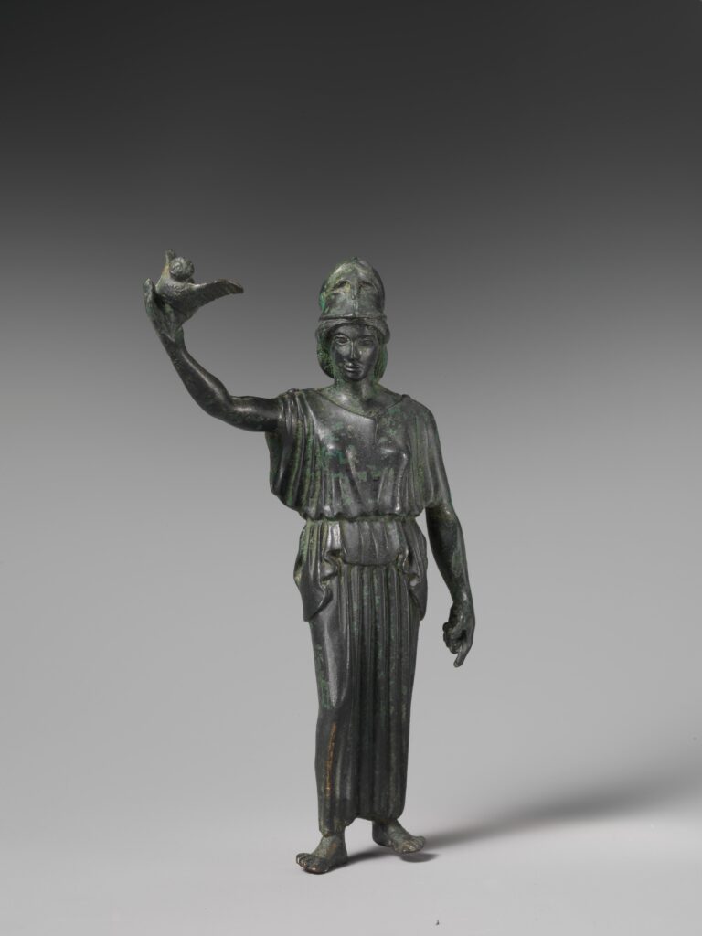Ancient Greek bronze of helmeted Athena standing with an owl on her raised hand.