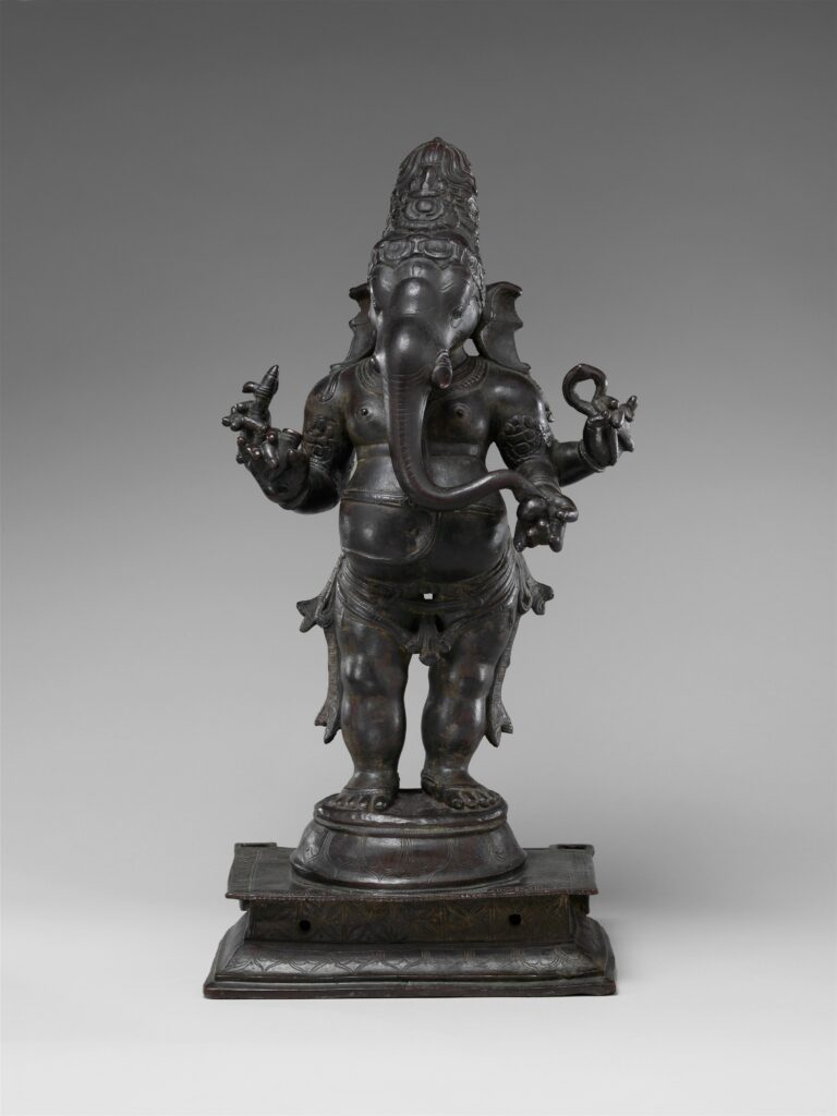 Chola-period copper-alloy Ganesha standing on a pedestal, with an elephant head and four arms.